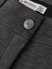 Close-up of a gray garment with a label and button detail