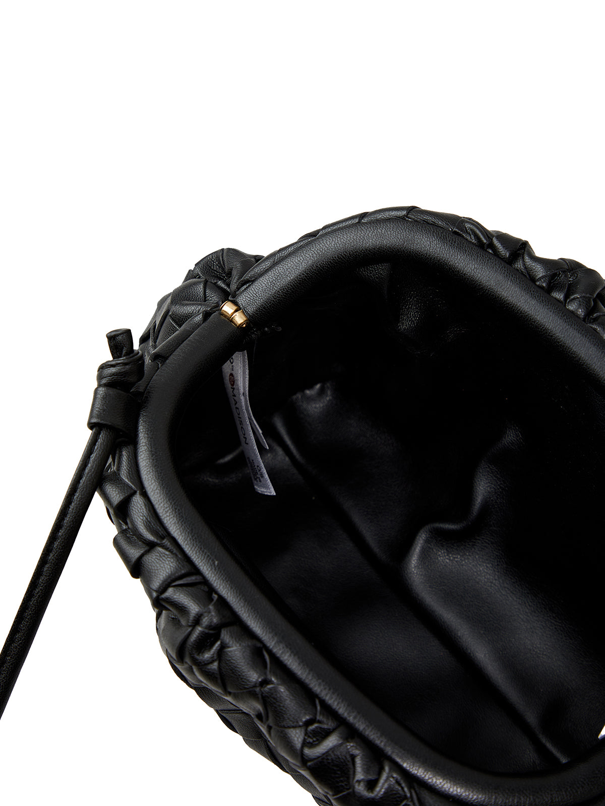 Close-up of a black leather bag with a strap on a white background