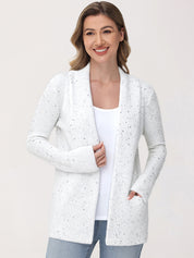 Woman wearing a white cardigan with a subtle pattern on a plain background