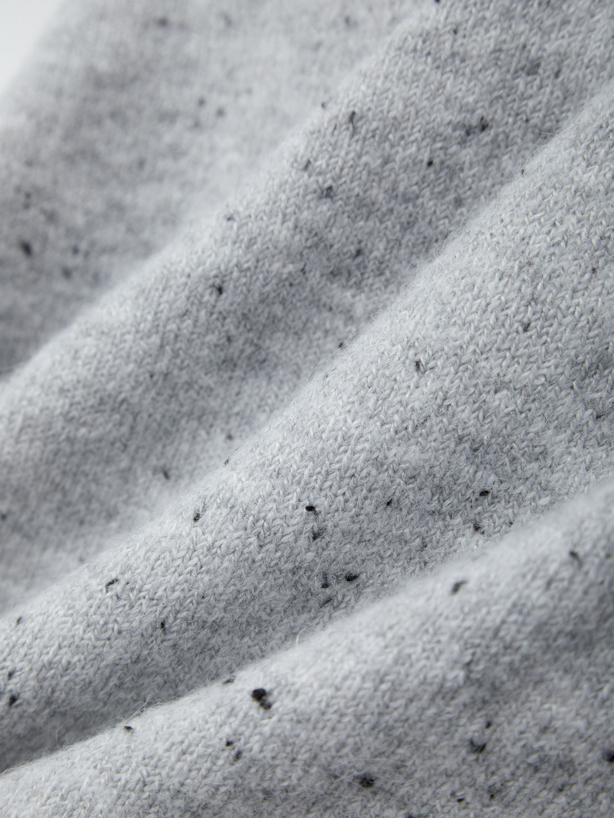 Close-up of textured gray fabric with a subtle pattern