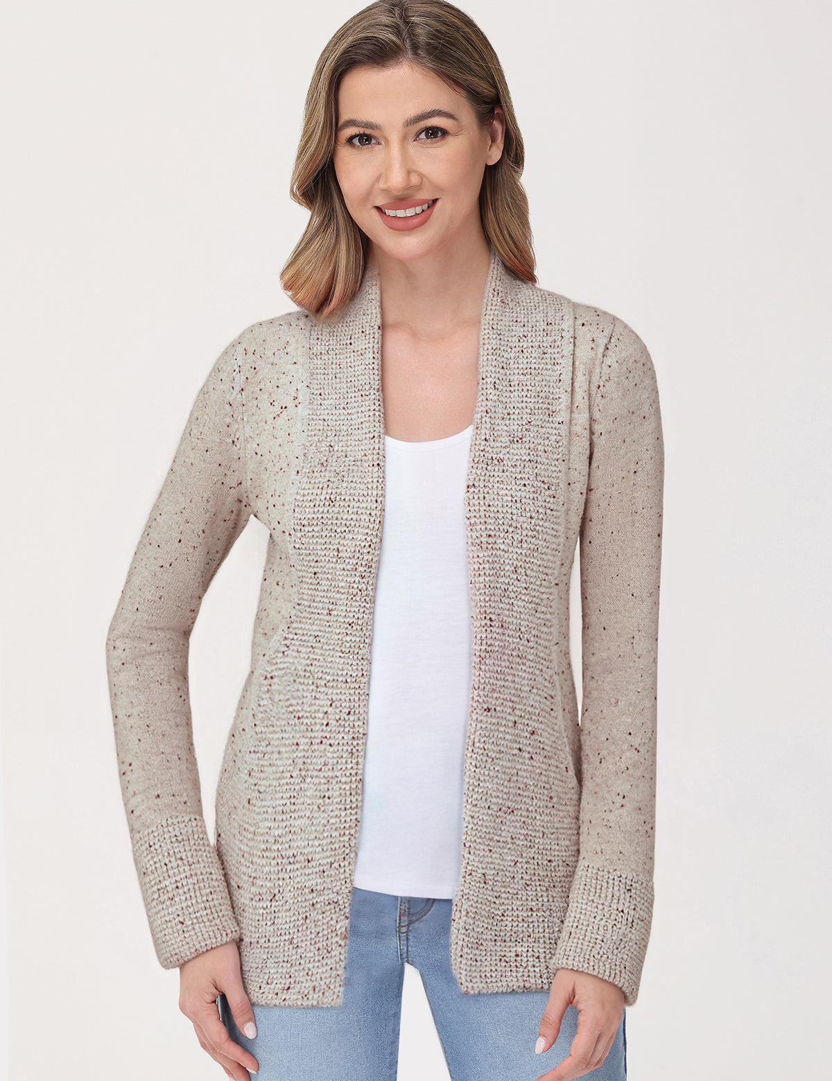 Woman wearing a beige cardigan over a white shirt on a white background