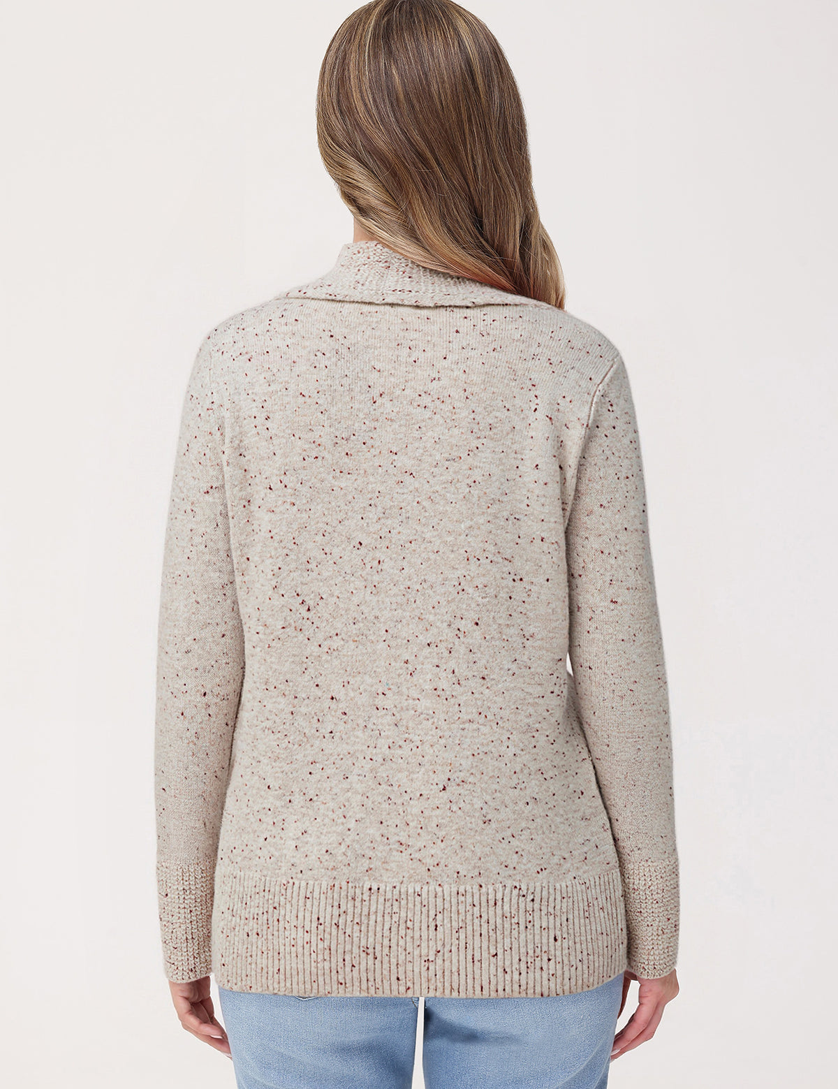 Woman wearing a beige knitted cardigan on a white background