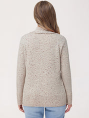 Woman wearing a beige knitted cardigan on a white background