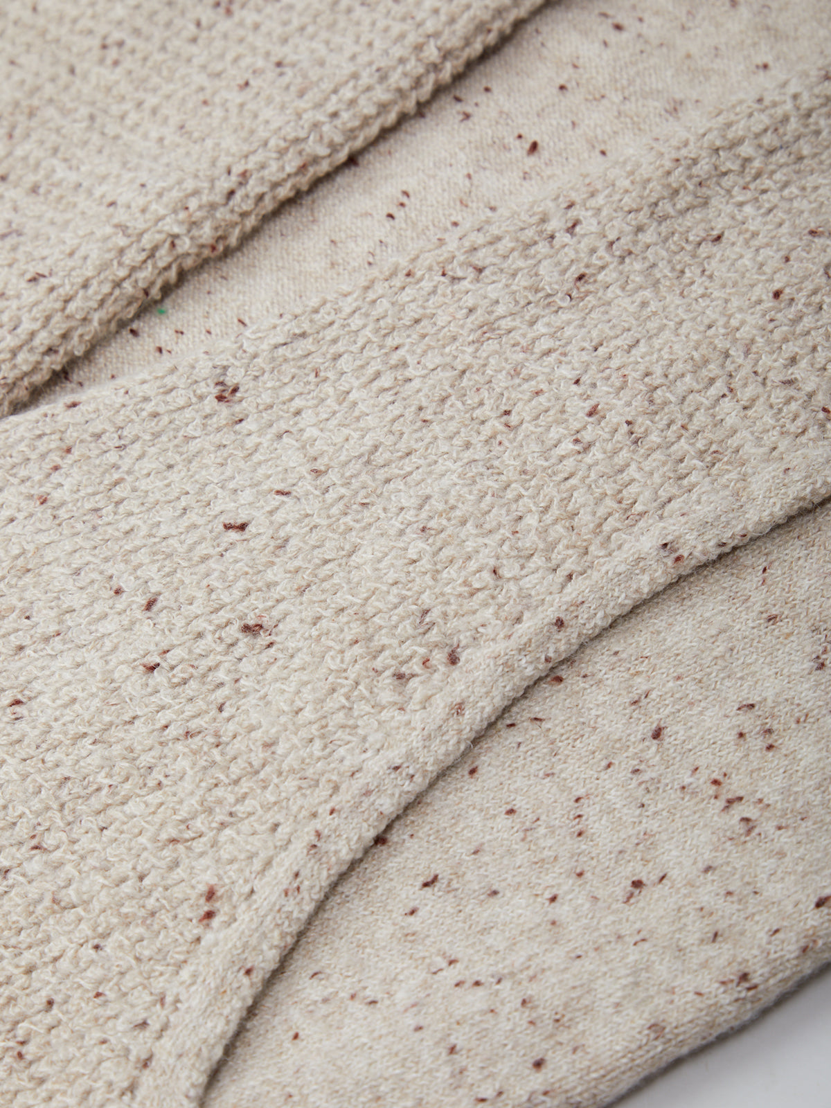 Close-up of beige fabric with a textured pattern