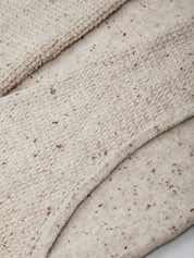 Close-up of beige fabric with a textured pattern