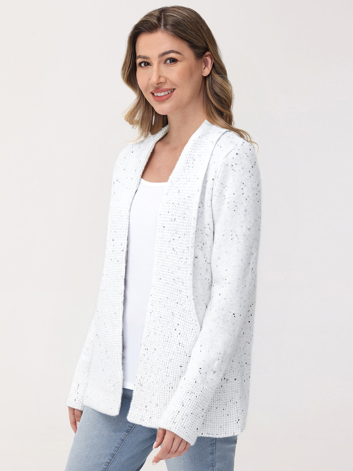 Woman wearing a white blazer with small patterns on a plain background