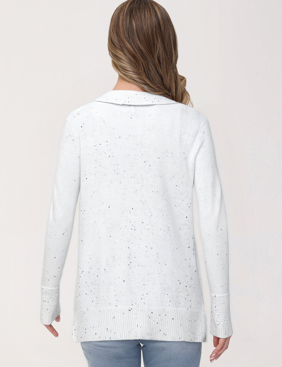 Woman wearing a light blue cardigan with a subtle pattern on a plain background