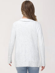 Woman wearing a light blue cardigan with a subtle pattern on a plain background