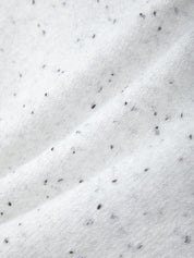 Close-up of white fabric with black specks