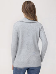 Person wearing a light gray knitted cardigan on a white background