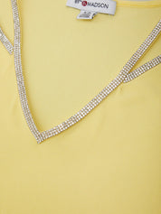 Yellow top with a decorative neckline on a yellow background, featuring the brand '89TH Madison'.