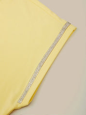 Yellow fabric with a decorative silver trim on a beige background