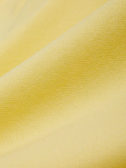 Close-up of yellow fabric with a subtle texture