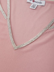 Pink garment with a decorative neckline featuring rhinestones, branded 'S.P. & MADISON'.