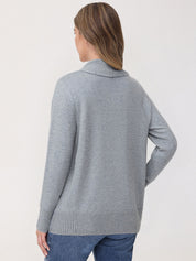 Woman wearing a gray sweater against a white background