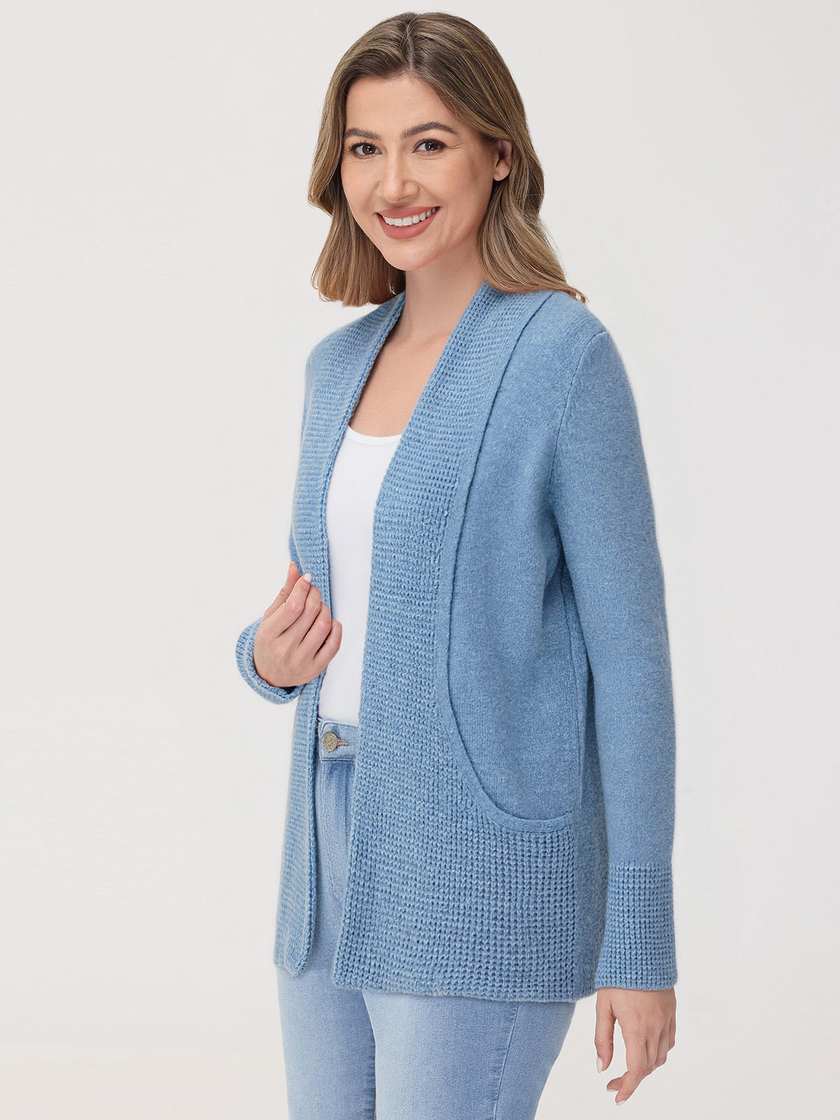 Woman wearing a blue cardigan on a white background