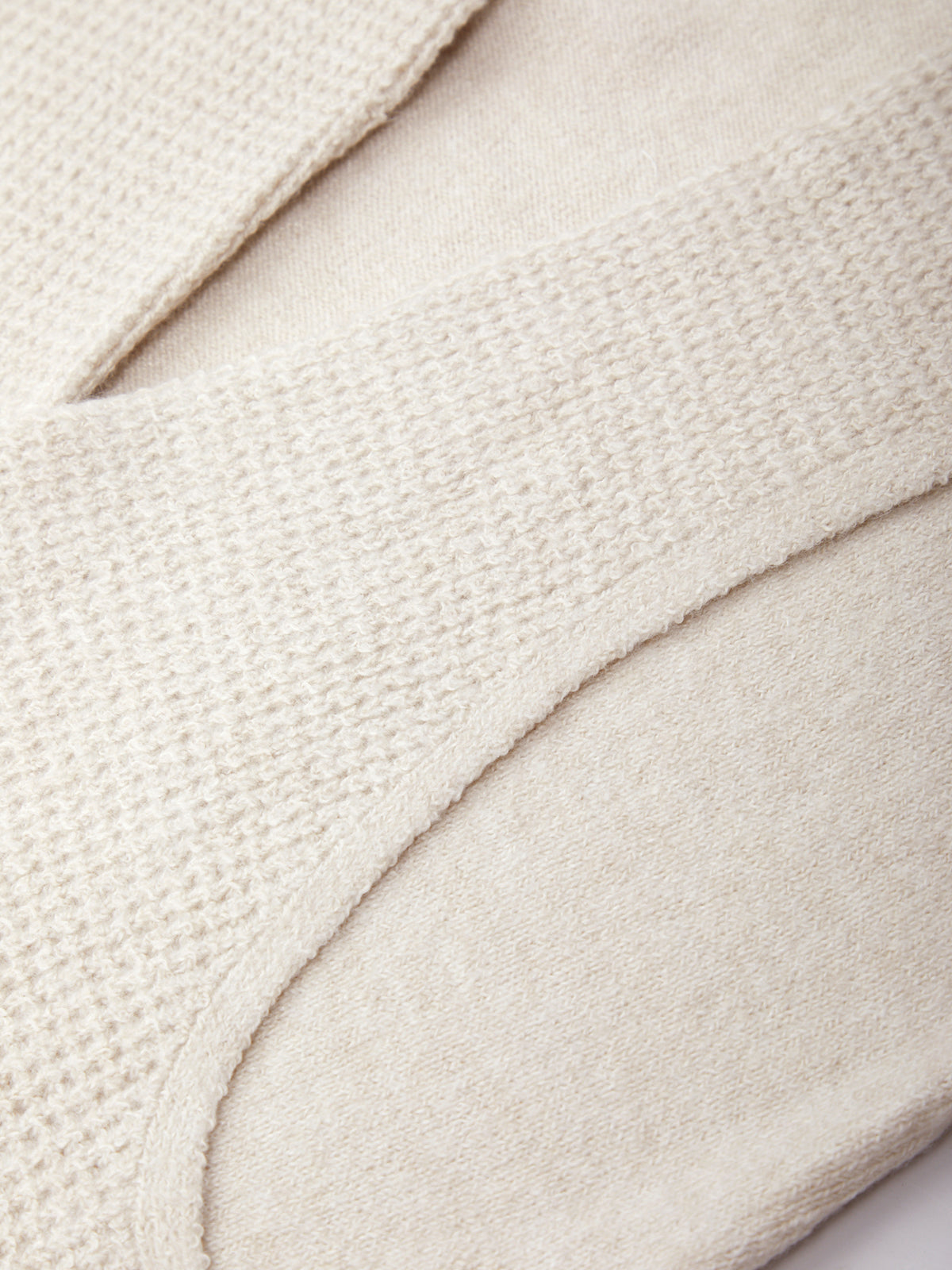Close-up of a textured beige fabric surface