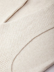 Close-up of a textured beige fabric surface