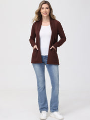 Woman wearing a brown cardigan, white shirt, blue jeans, and white sneakers on a white background