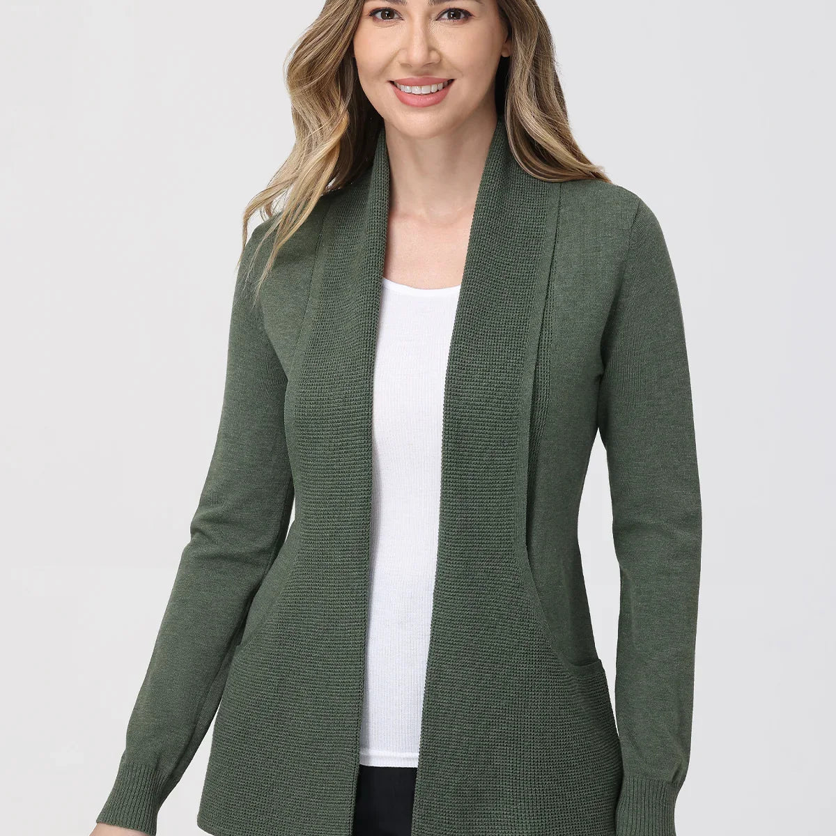 Woman wearing a green cardigan over a white top on a white background