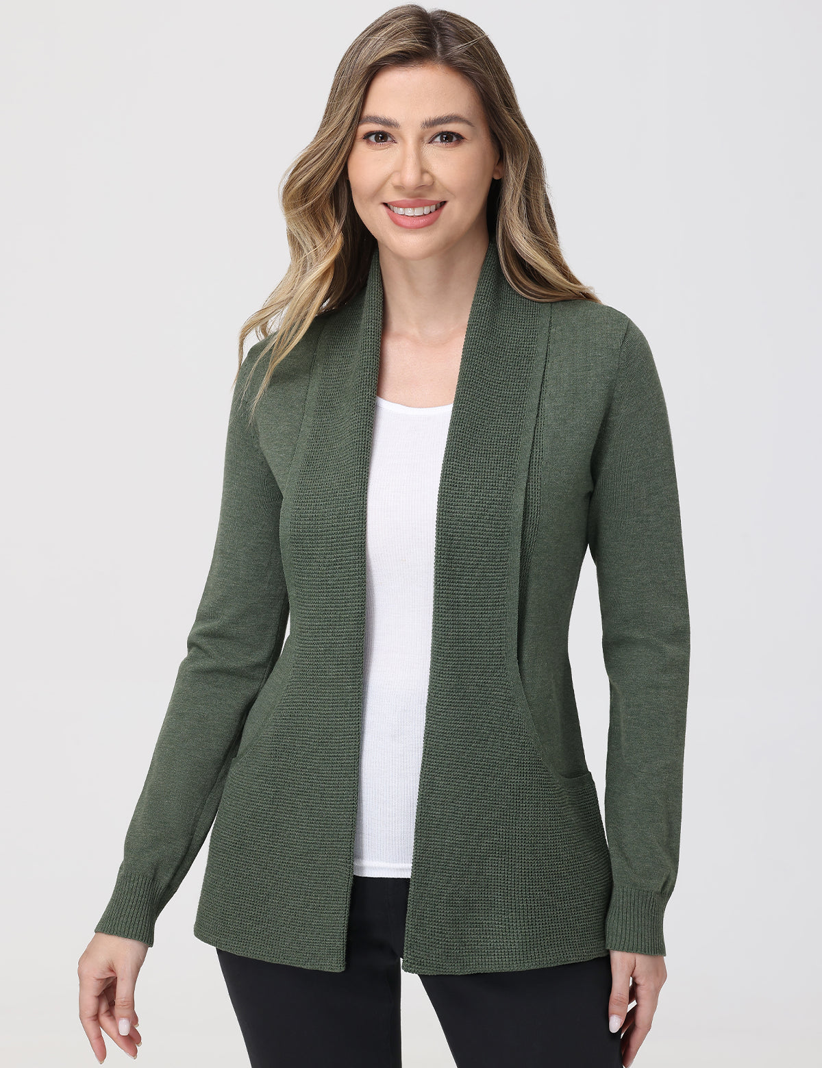 Woman wearing a green cardigan over a white top on a white background