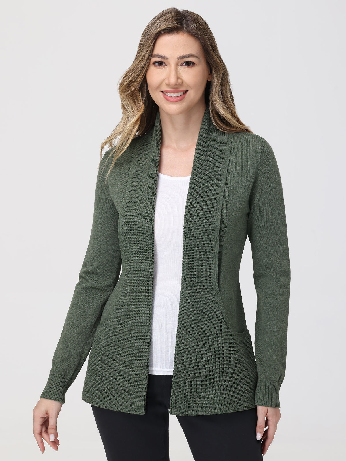 Woman wearing a green cardigan over a white top on a white background