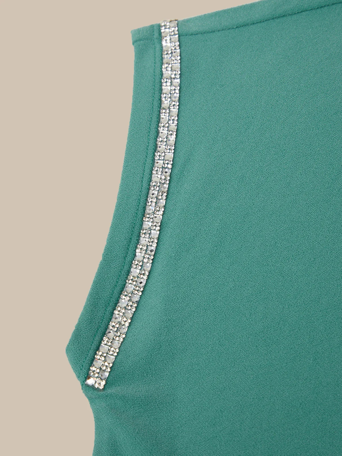 Teal fabric with a silver trim on a beige background