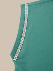 Teal fabric with a silver trim on a beige background