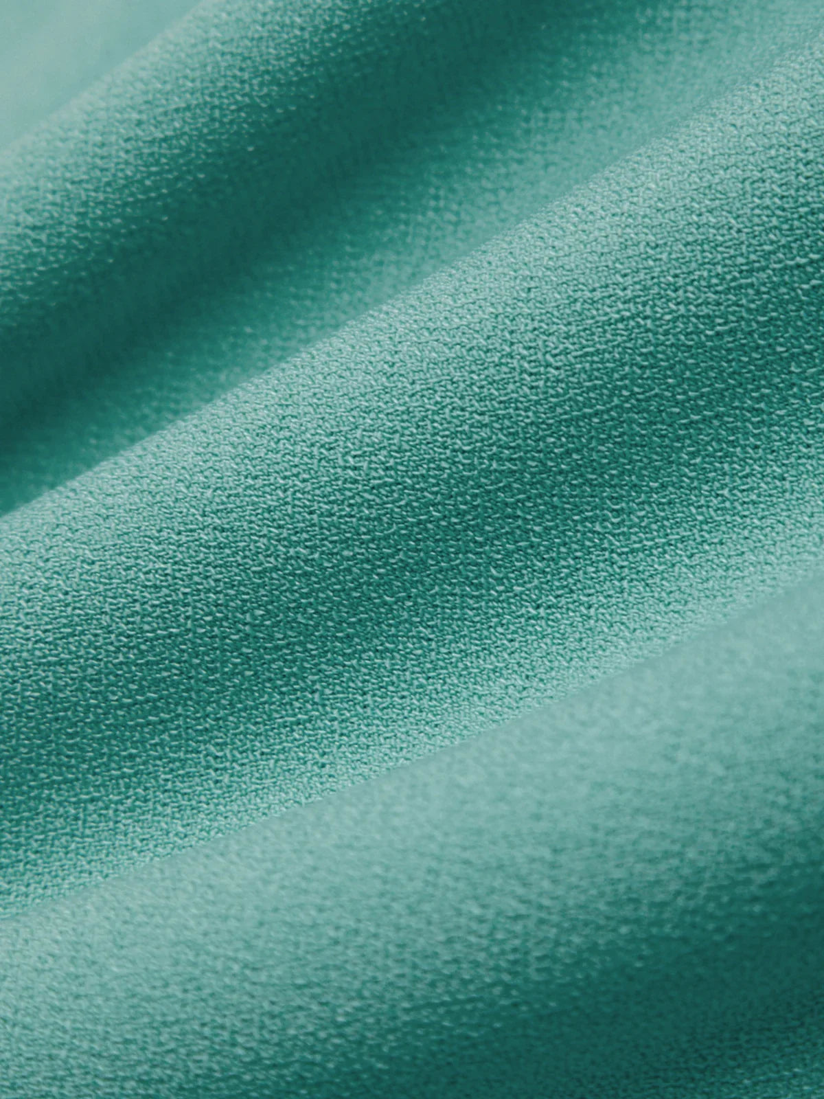 Close-up of teal fabric with a soft texture