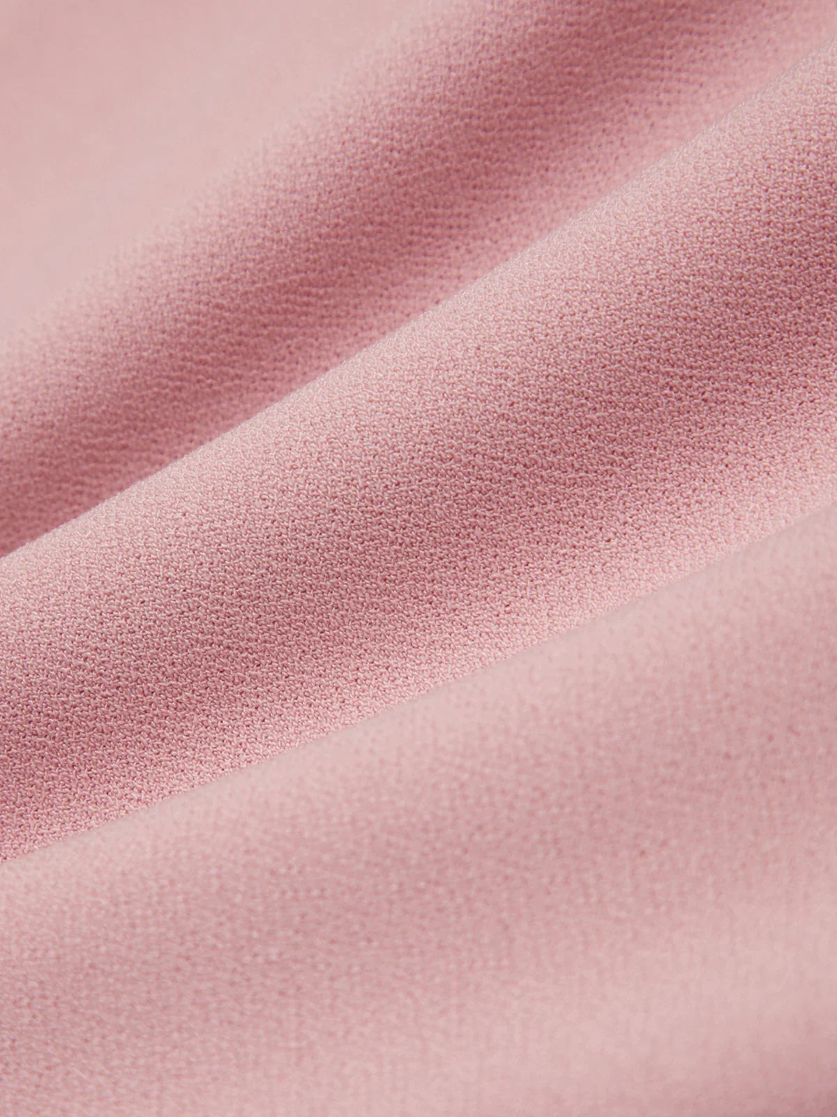 Close-up of pink fabric with a subtle texture
