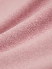 Close-up of pink fabric with a subtle texture