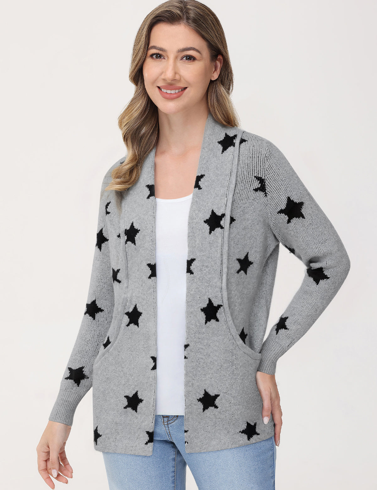 Woman wearing a gray cardigan with black star patterns on a white background