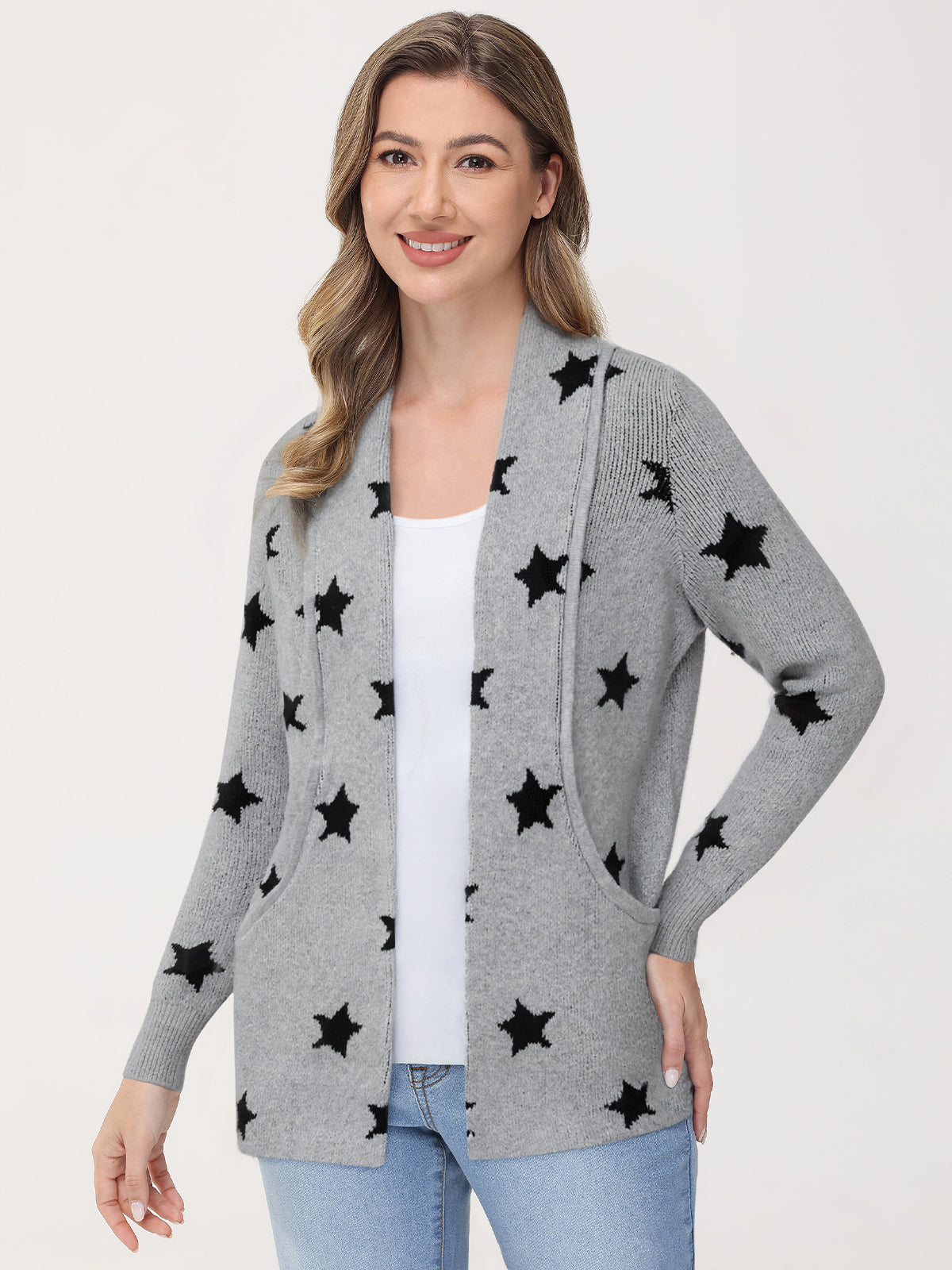 Woman wearing a gray cardigan with black star patterns on a white background