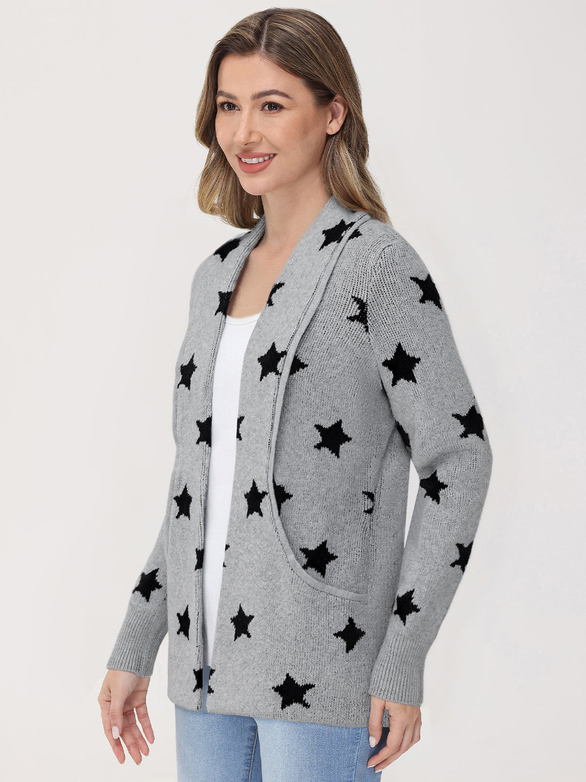 Woman wearing a gray cardigan with black star patterns on a white background