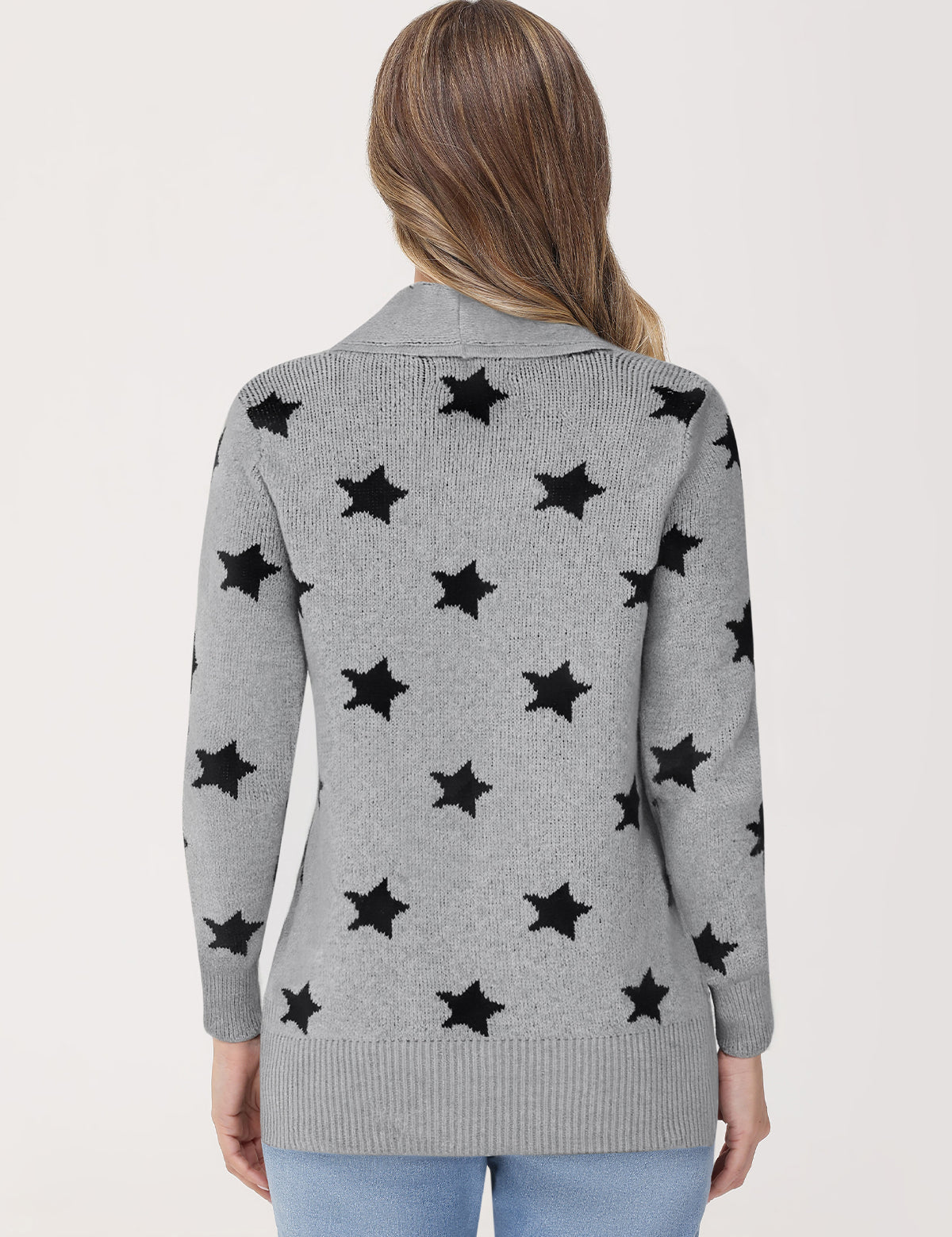 Gray cardigan with black star patterns worn by a person on a light gray background