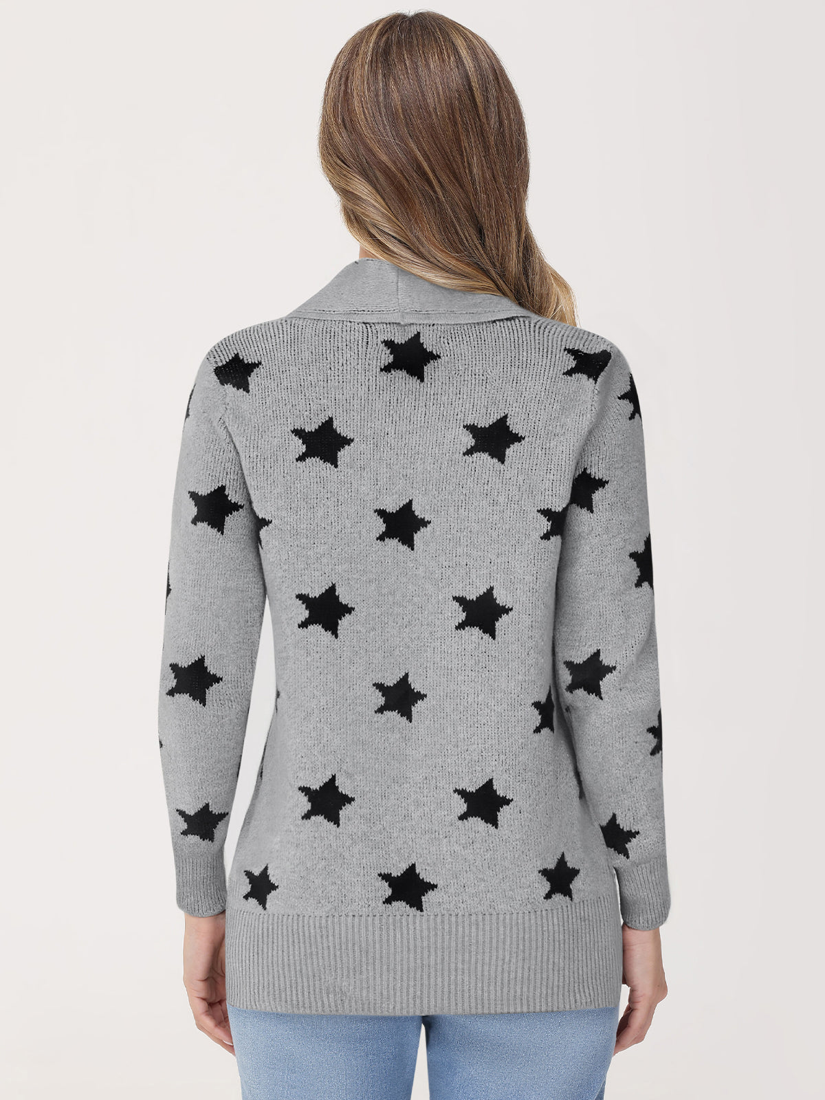 Gray cardigan with black star patterns worn by a person on a light gray background