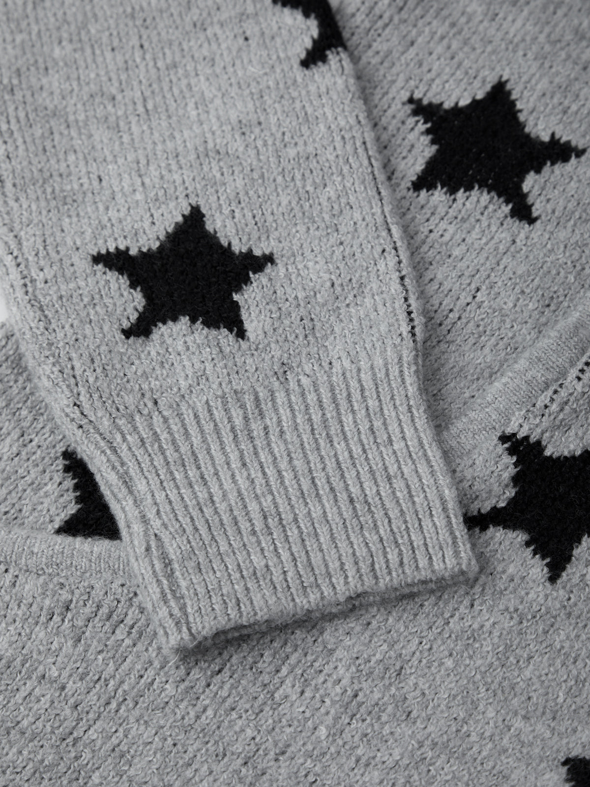 Gray socks with black star patterns on a matching background