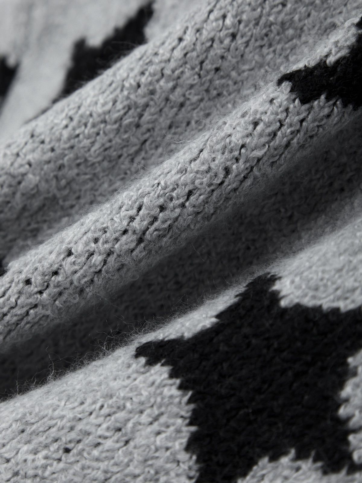 Close-up of a knitted fabric with black and white pattern