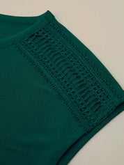 Green garment with lace detailing on a beige background