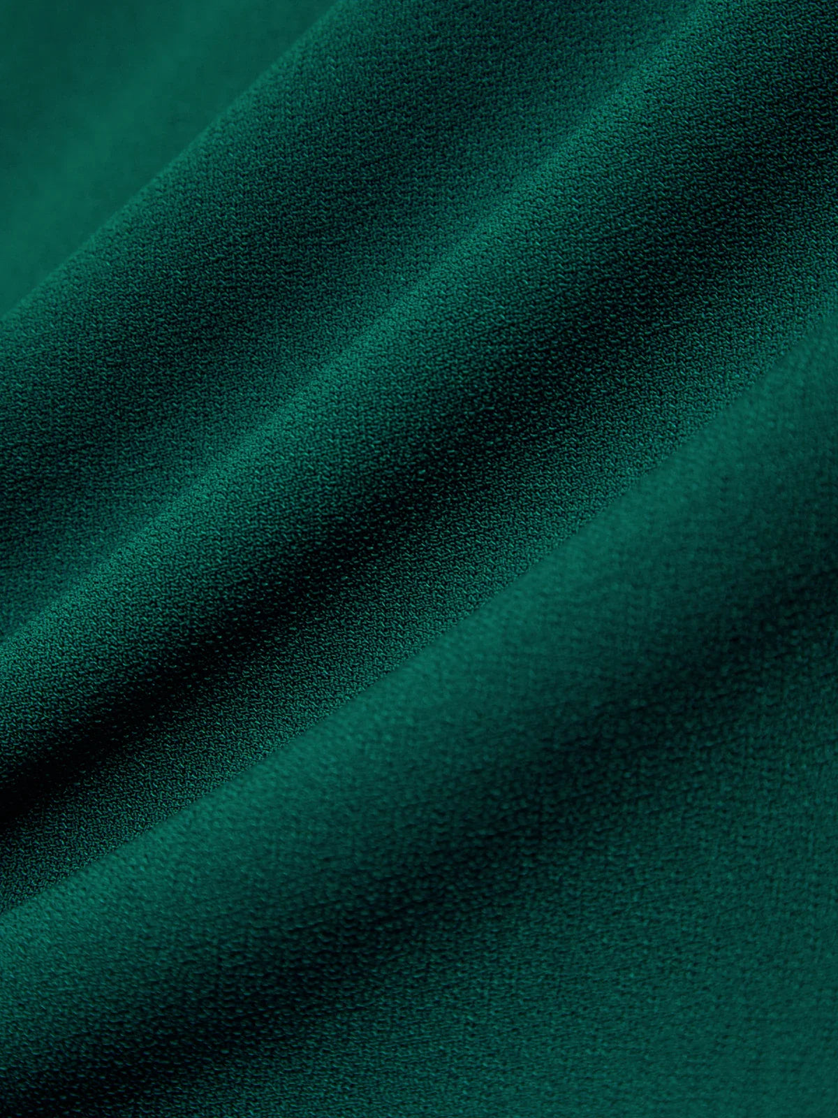 Close-up of dark green fabric with visible texture