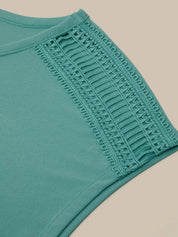 Teal fabric with lace trim on a beige background