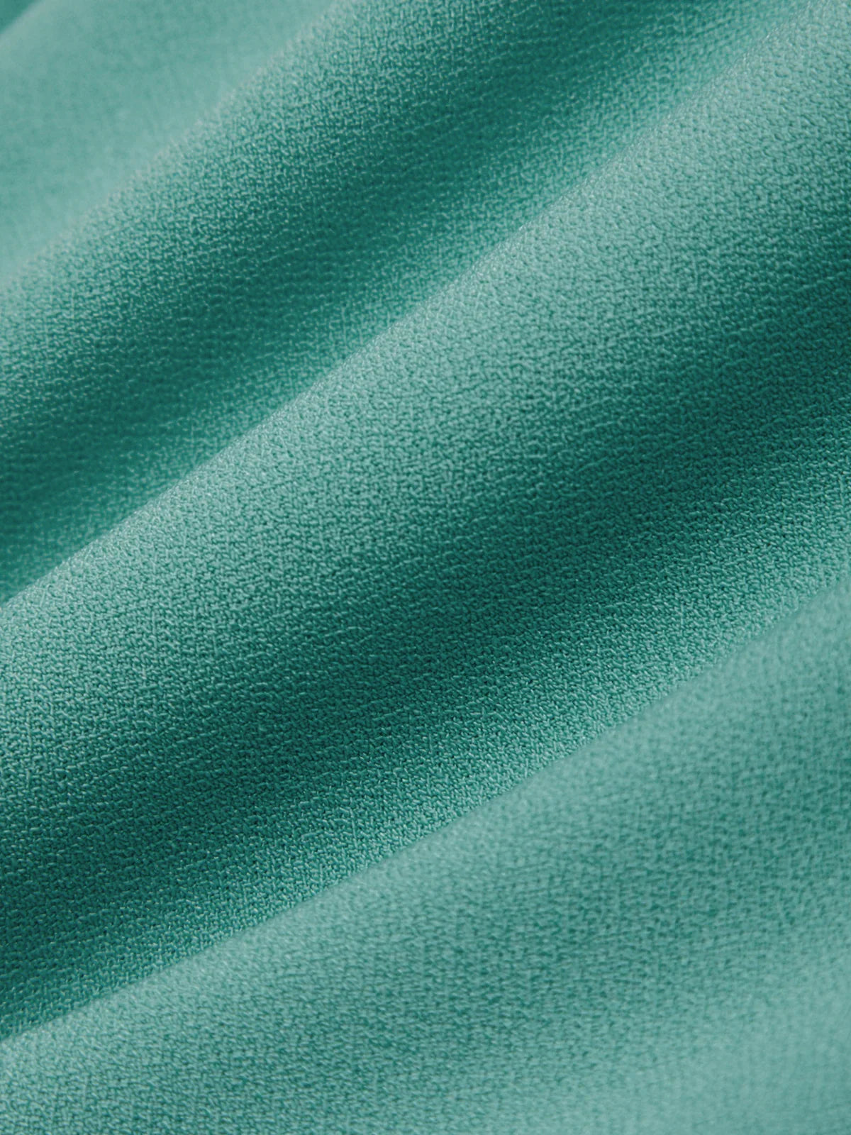 Close-up of teal fabric with a soft texture