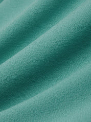 Close-up of teal fabric with a soft texture
