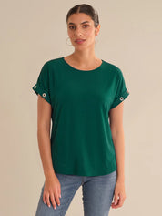 Woman wearing a green top against a beige background