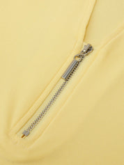 Close-up of a zipper on a yellow garment