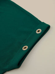 Green fabric with decorative eyelets on a beige background