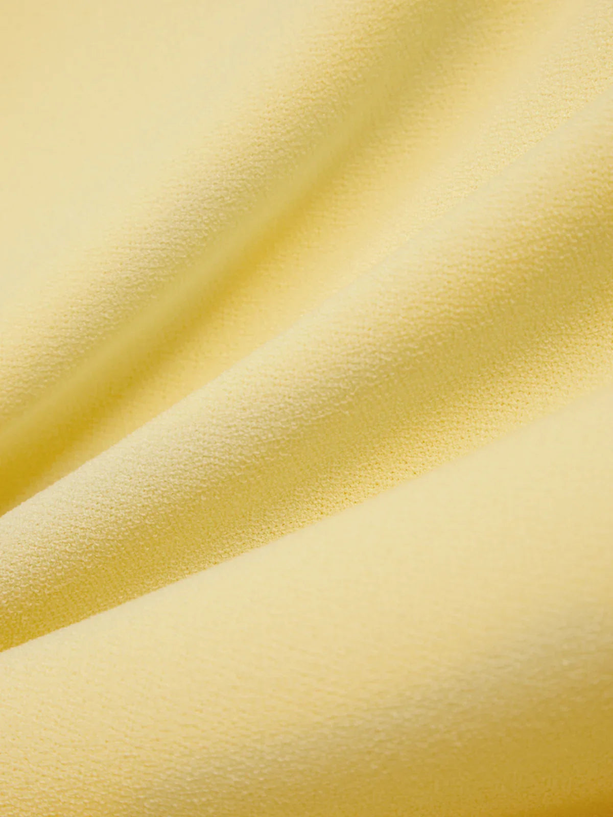 Close-up of yellow fabric with a soft texture