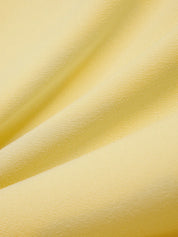Close-up of yellow fabric with a soft texture