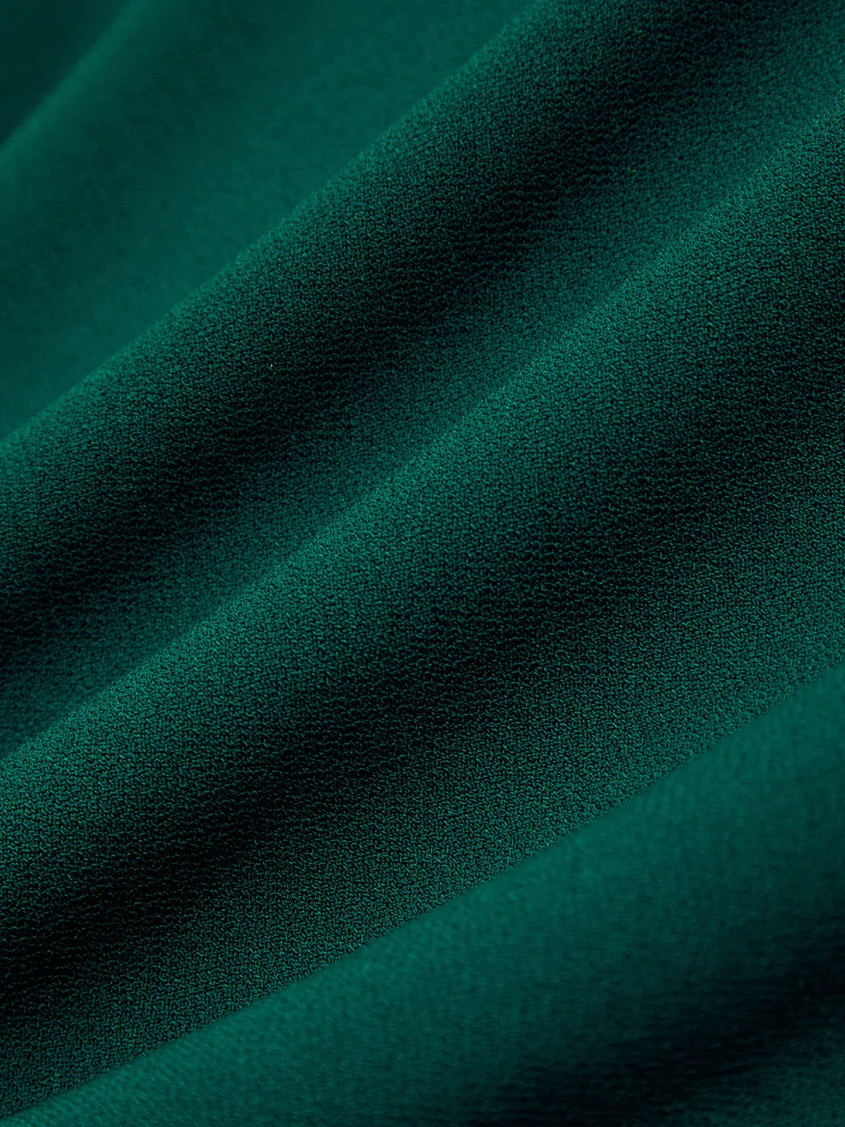 Close-up of teal fabric with a textured surface