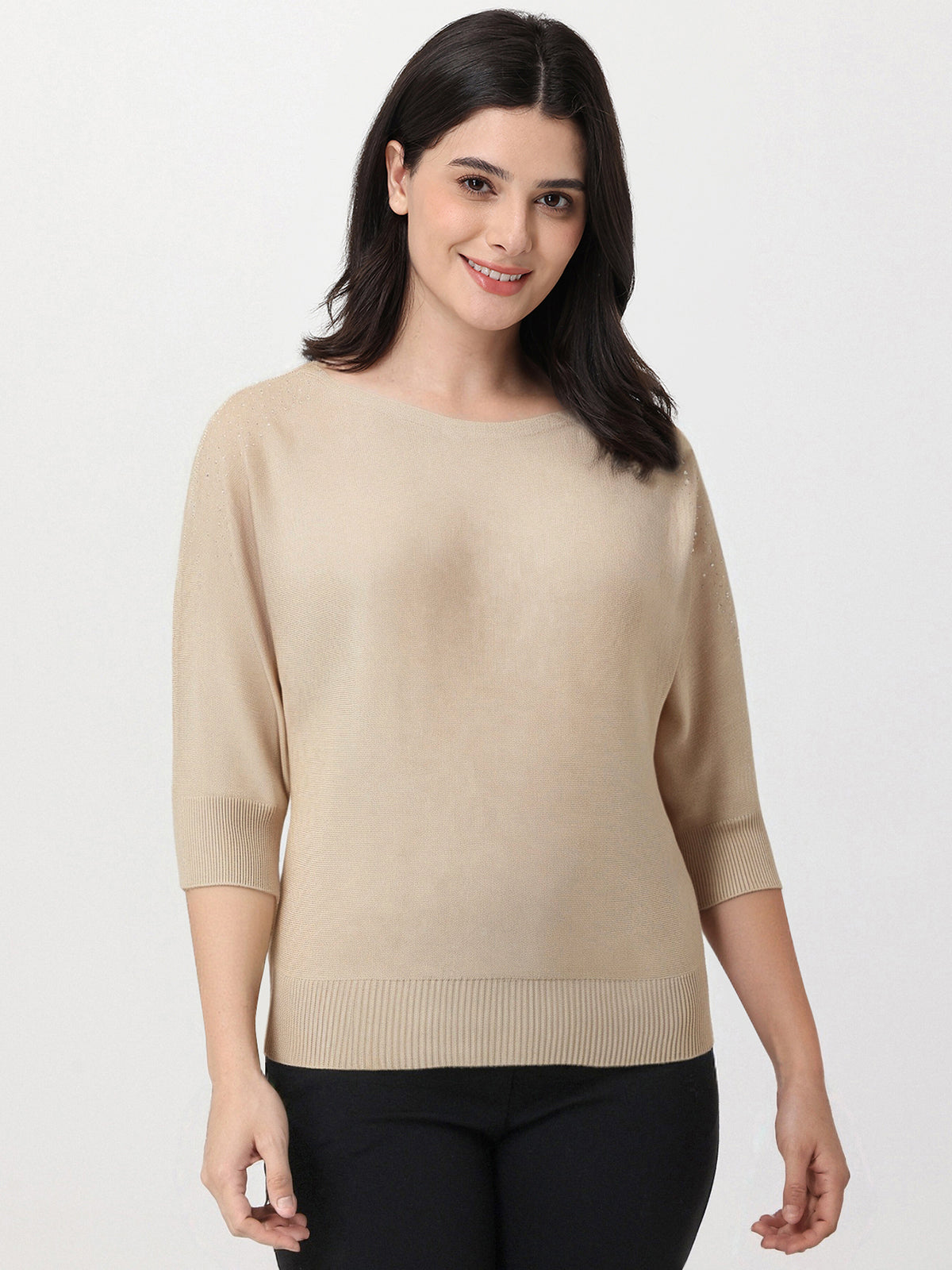 Woman wearing a beige sweater on a white background